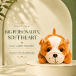 Right-side view of a cute lying brown and white bulldog plush toy resting on a cream-colored display pedestal against a soft arched background.