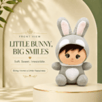 Right-side view of a cute plush doll wearing a grey bunny onesie with long ears, sitting on a cream display pedestal under soft lighting.