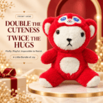 Front view of a fluffy red plush bear wearing a character hood with an embroidered face emblem sitting on a marble display.